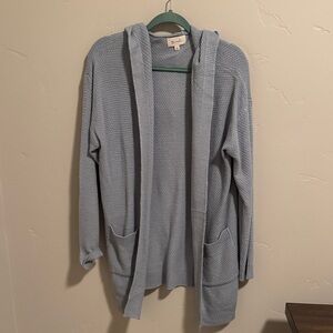 Light blue hooded open front cardigan with two front pockets